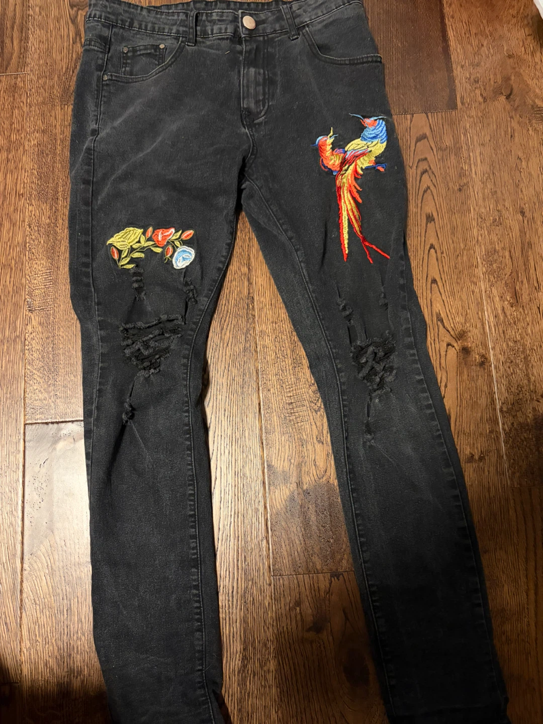 Embroidered black distressed jeans