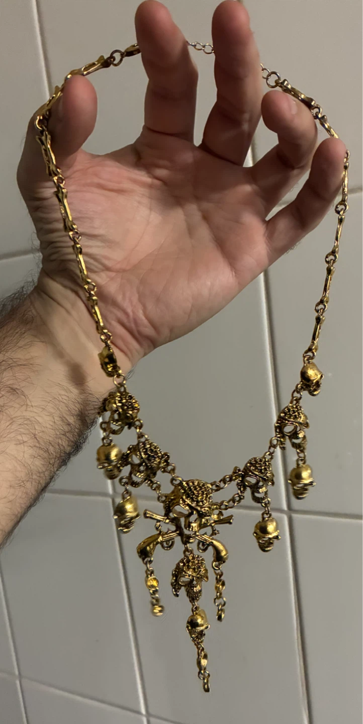 Gold-tone skull and pistol statement necklace