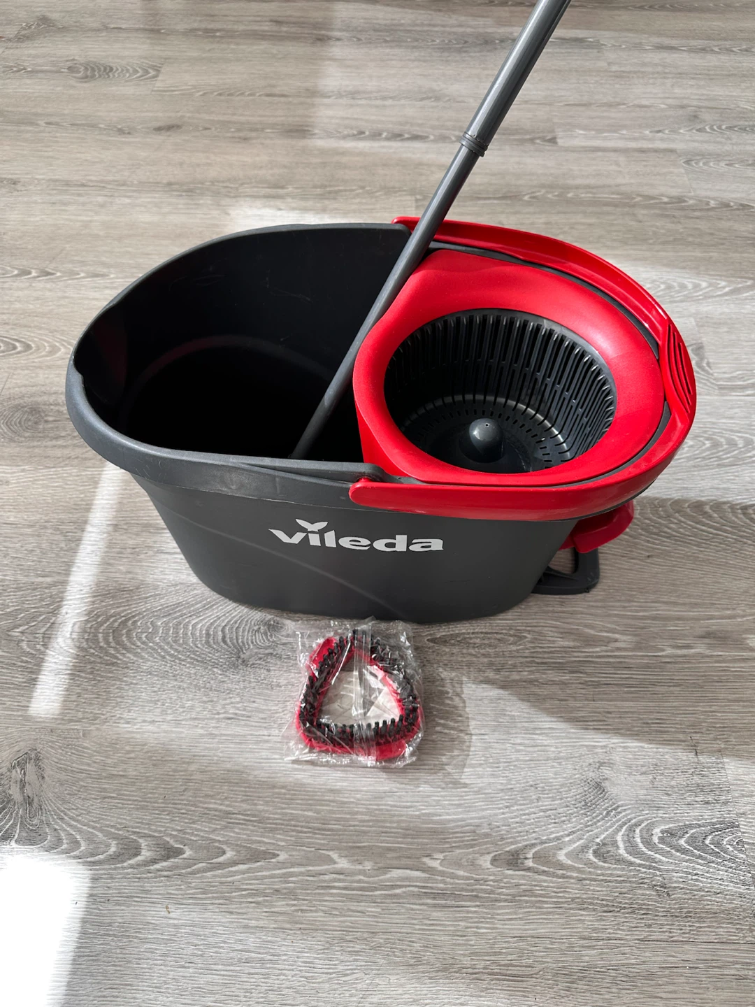 The Vileda EasyWring Spin Mop & Bucket with bristle brush