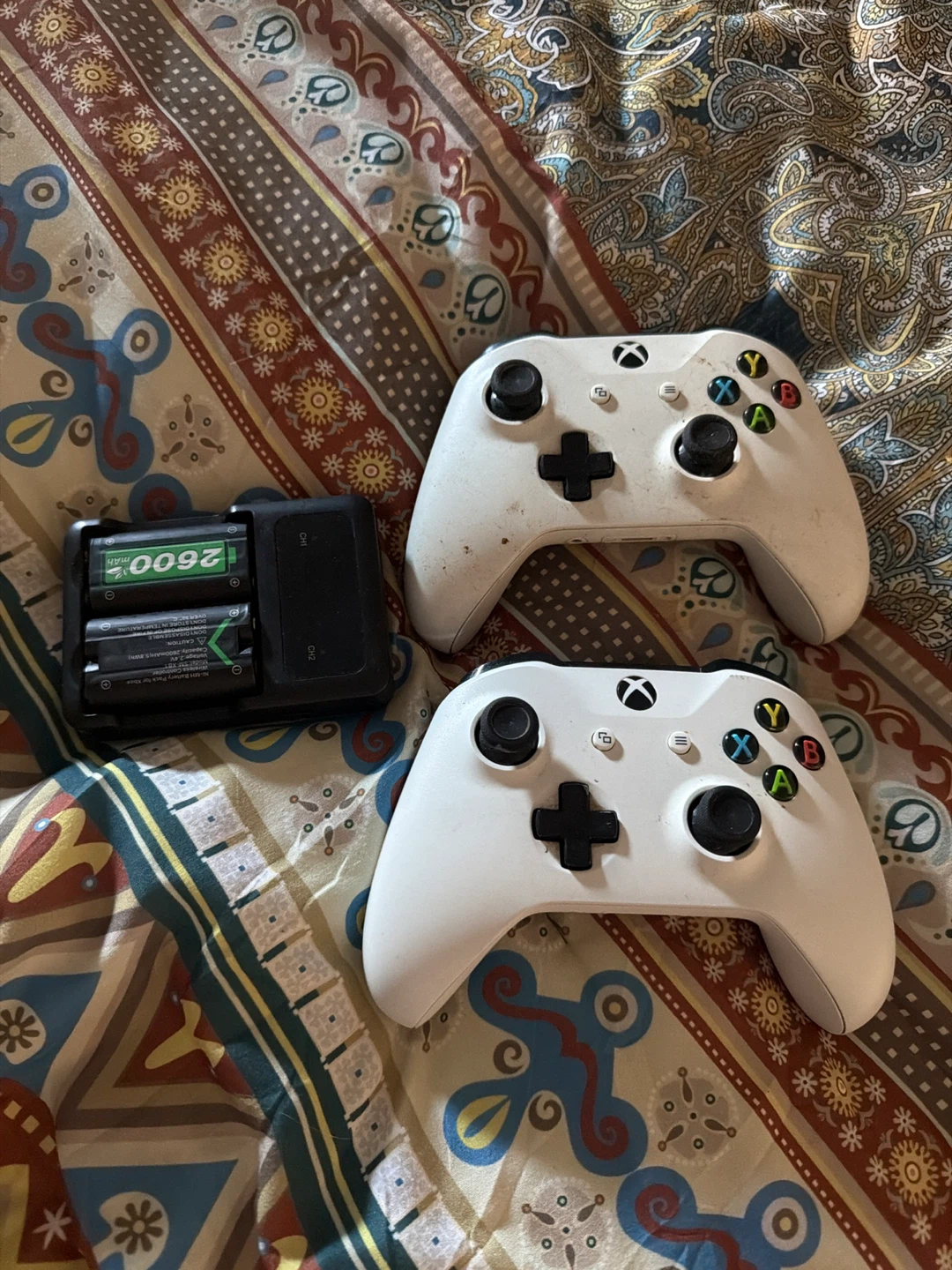 Two White Xbox Wireless Controllers with Battery Charger