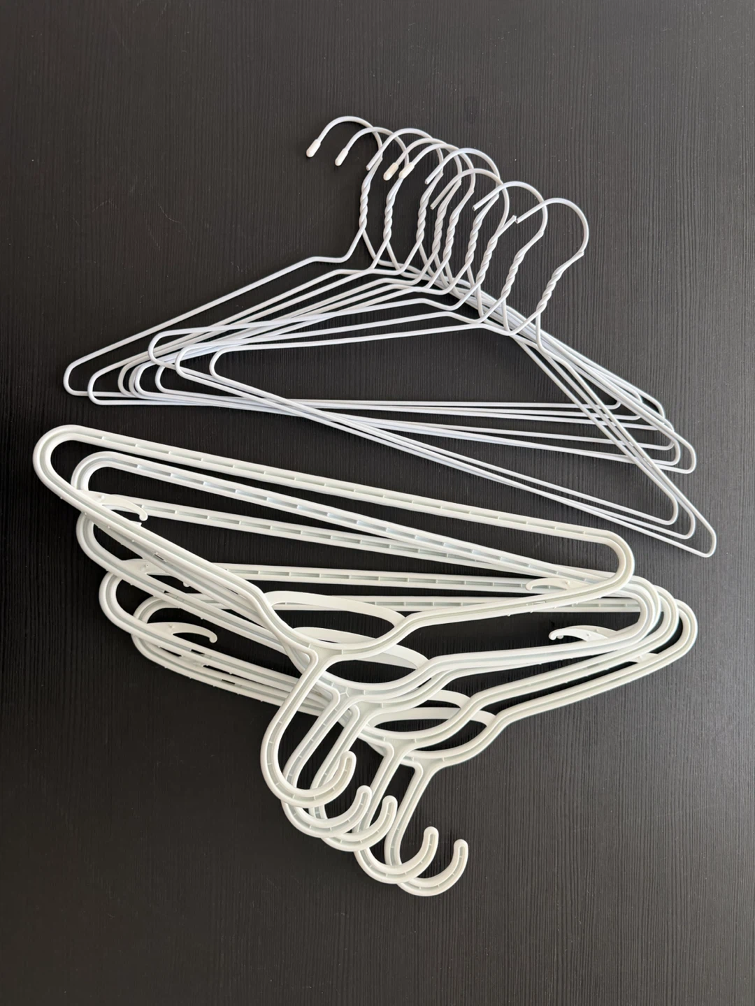 Assorted white clothes hangers