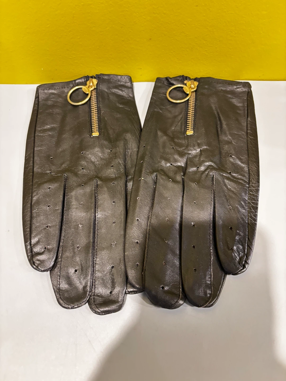 Black faux leather gloves with gold-tone zippers