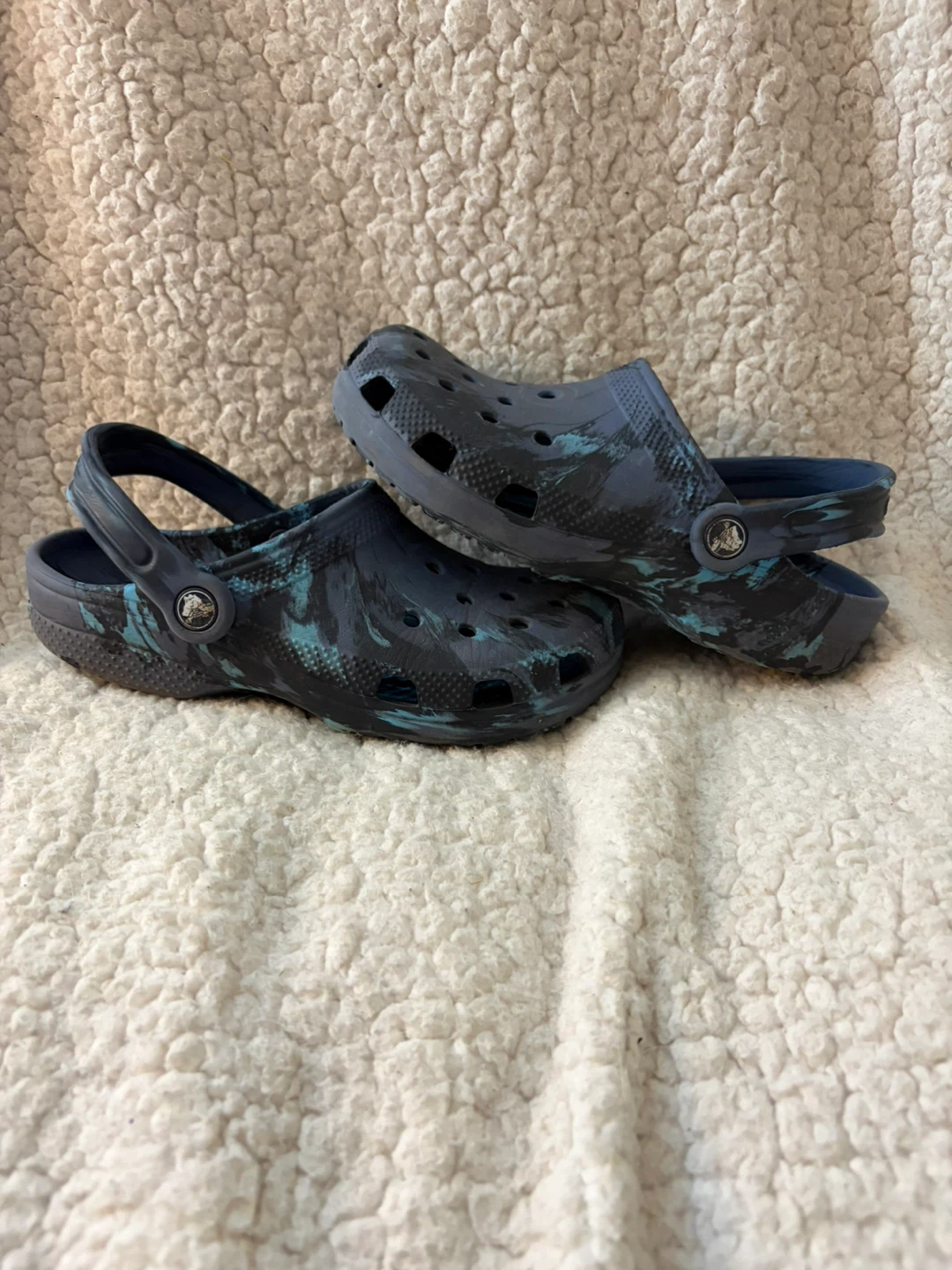 Crocs clogs in blue and black swirl pattern