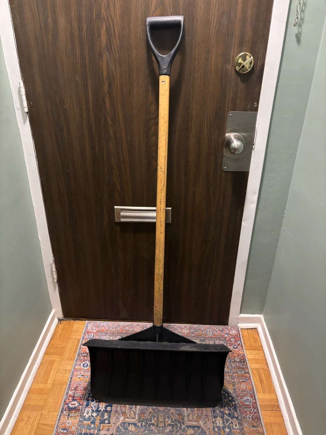 Heavy-duty snow shovel with wooden handle