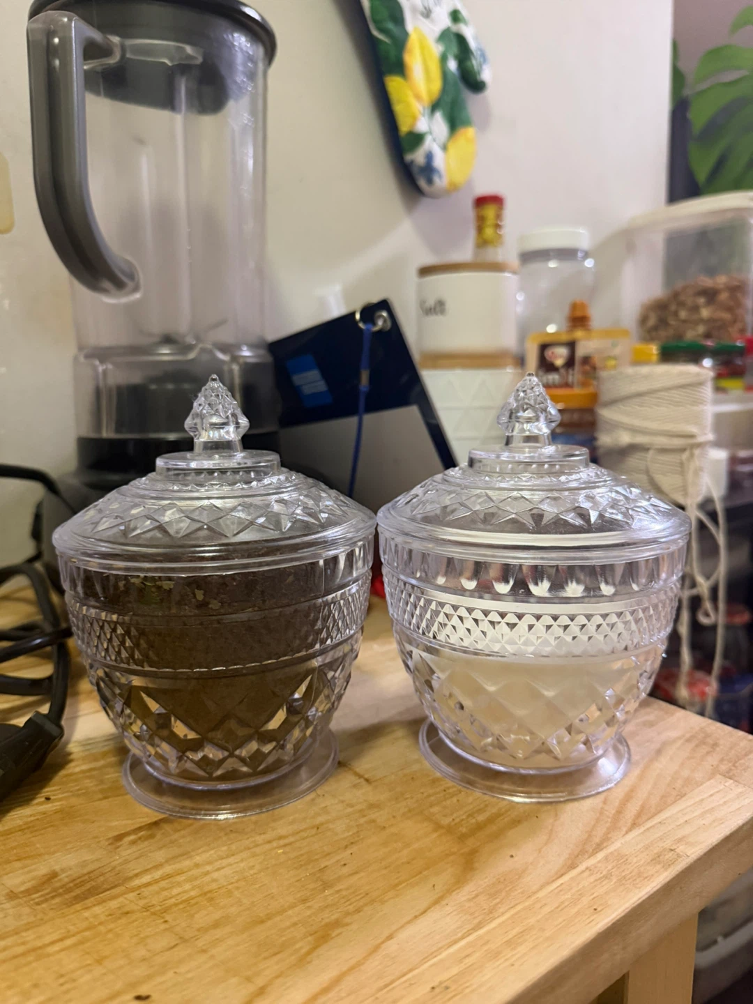 Two Clear Glass Lidded Jars