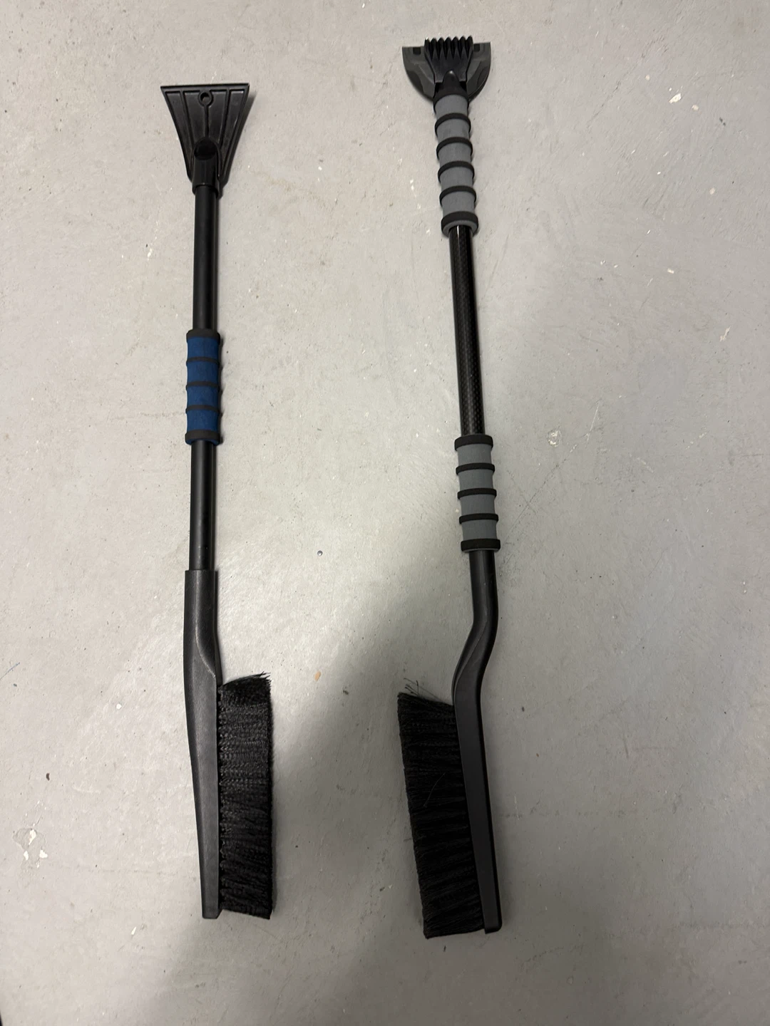 Two snow brushes with scrapers
