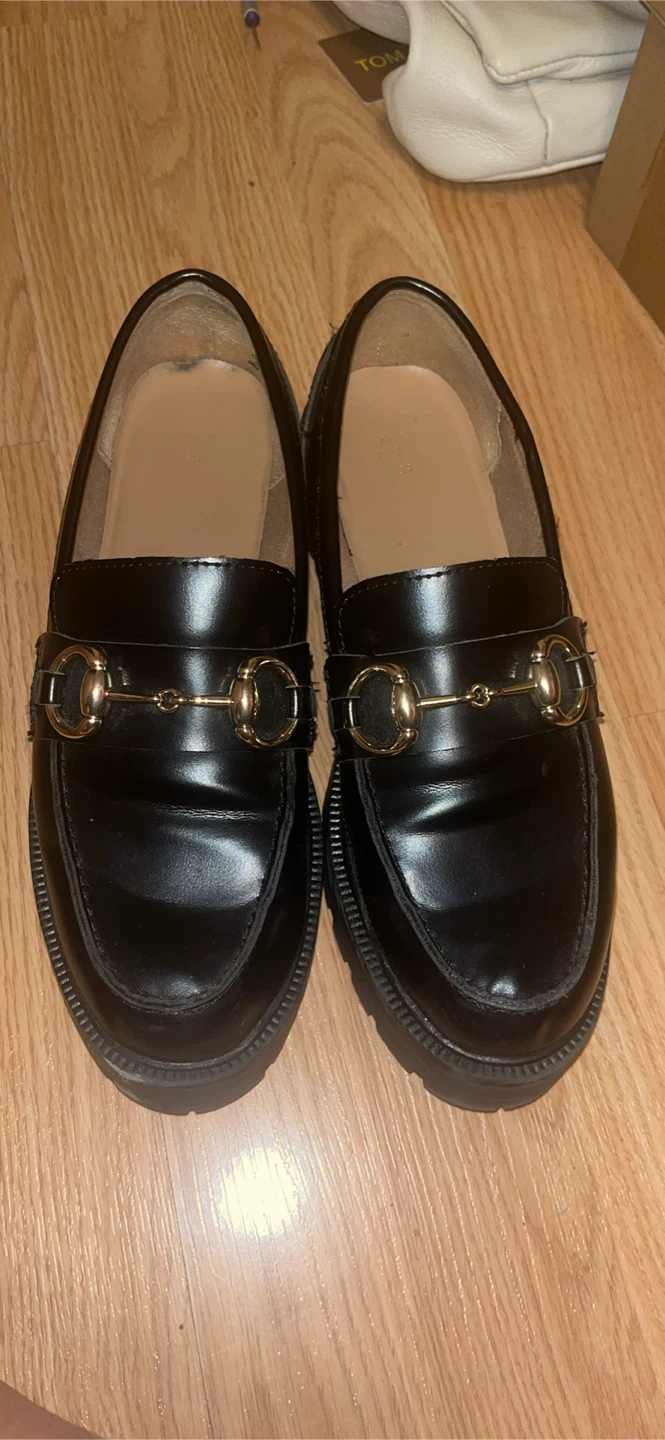 Get them now! H&M Black Loafers with Gold Hardware
