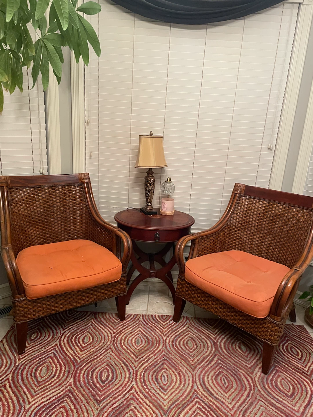 Two Wicker Accent Chairs with Orange Cushions