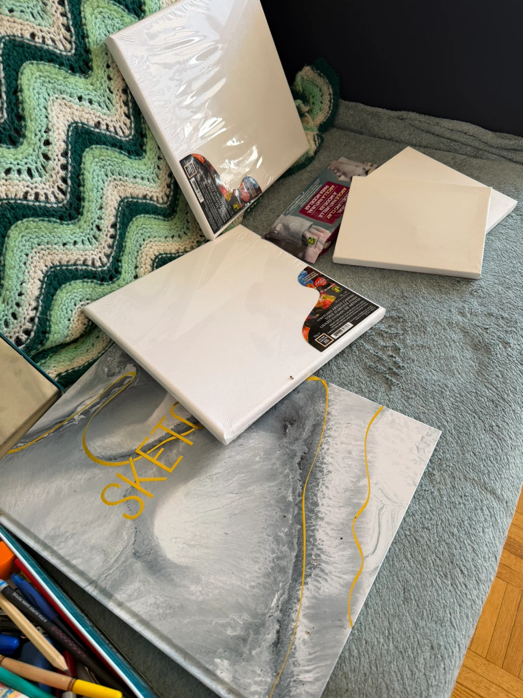 Assorted Art Supplies and Sketchbook