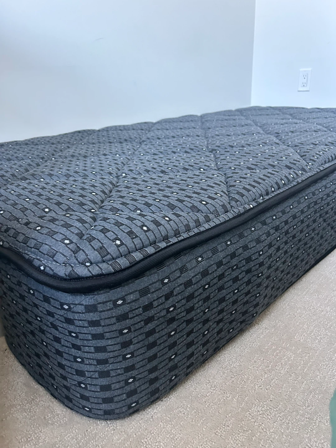 Single size mattress with grey patterned cover
