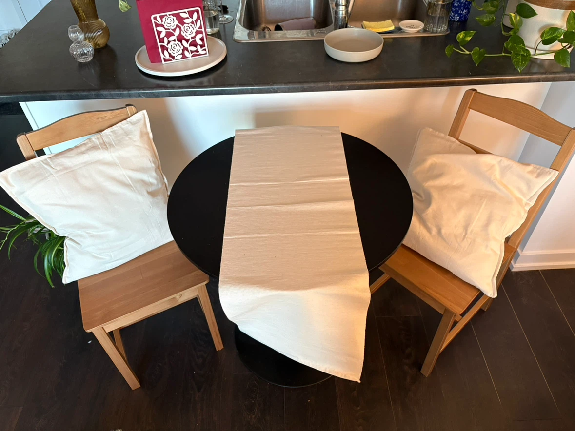 Black Metal Table and Two Wooden Chairs