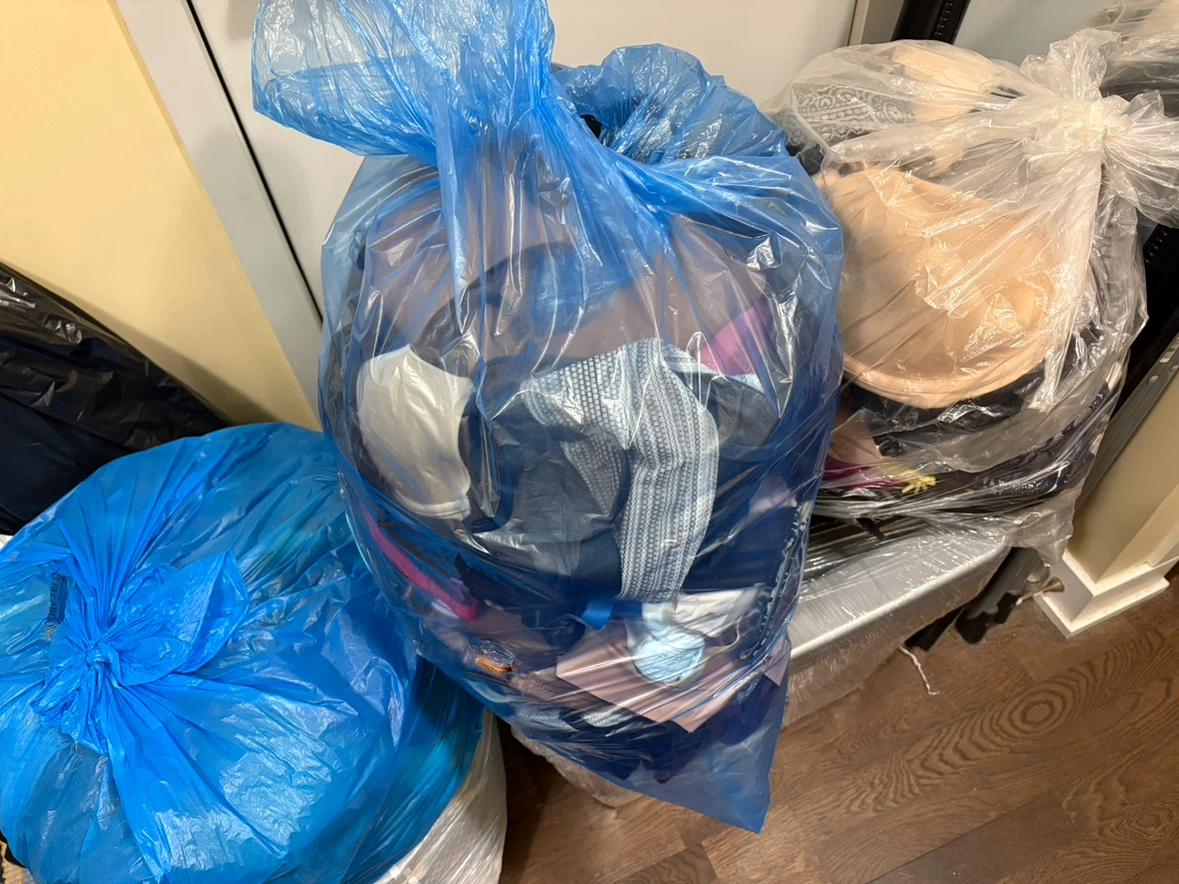 Four garbage bags of gently used bras