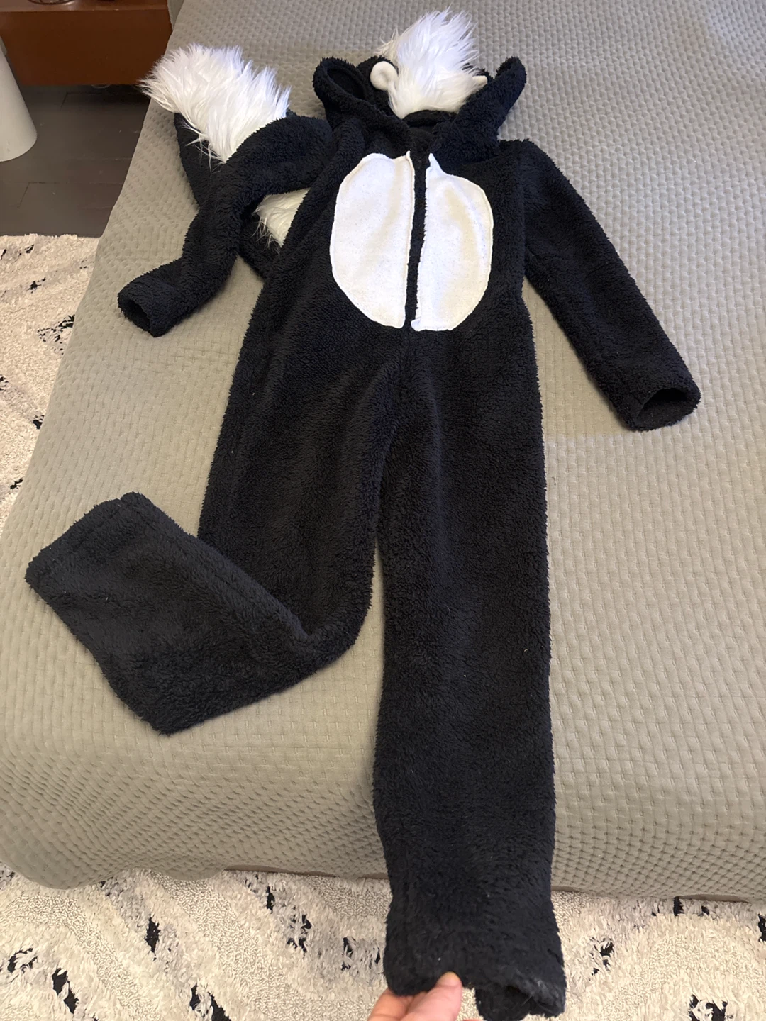 Black and white skunk onesie costume