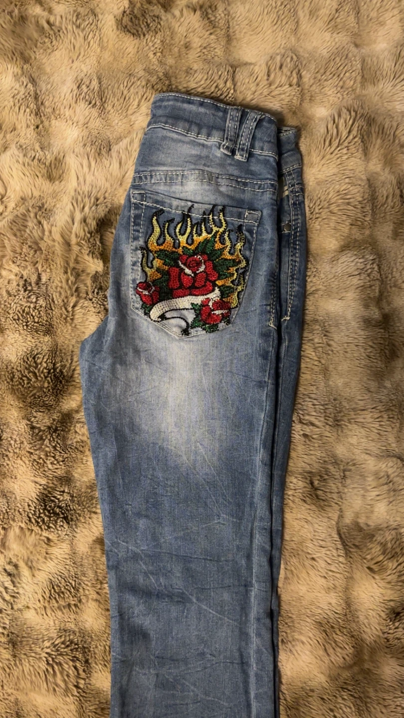 Light wash jeans with embroider and beaded back.