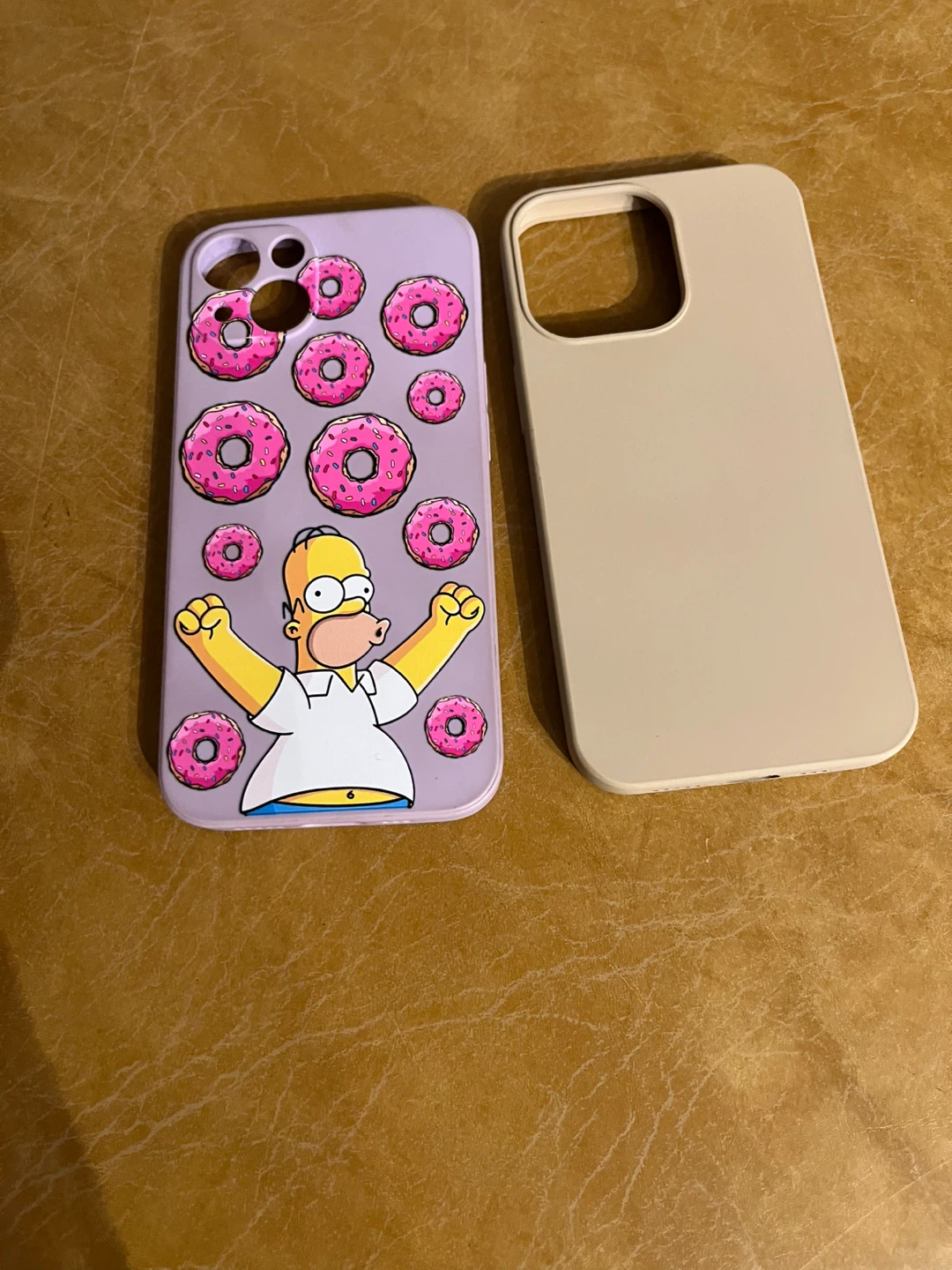 Two iPhone 13 cases, one Simpsons themed