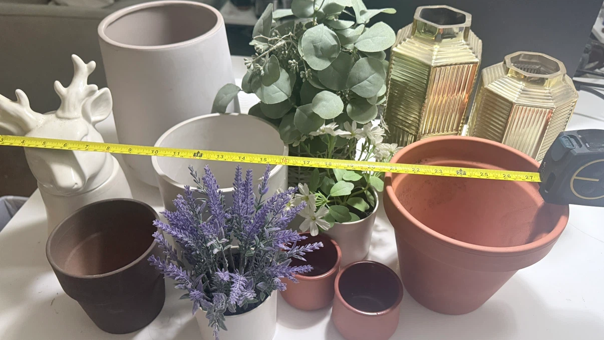Variety of ceramic pots and fake plants