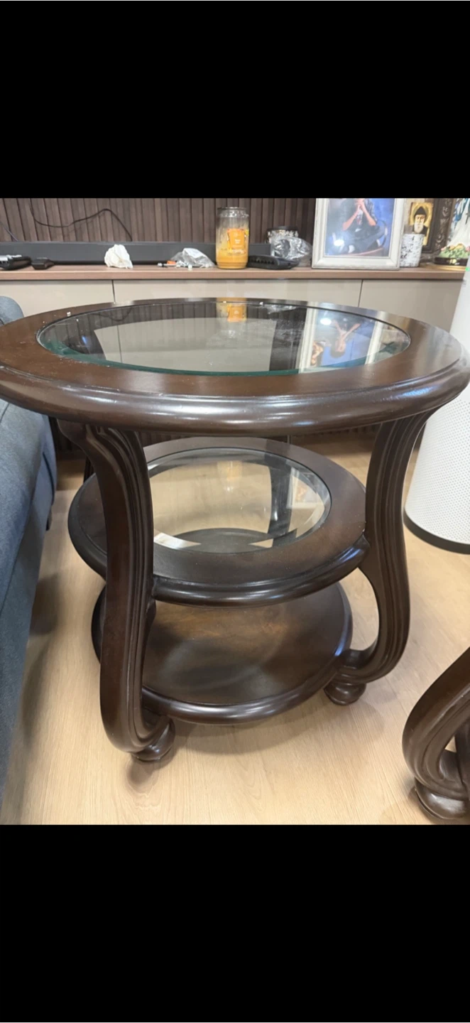 Set of two round dark wood side tables