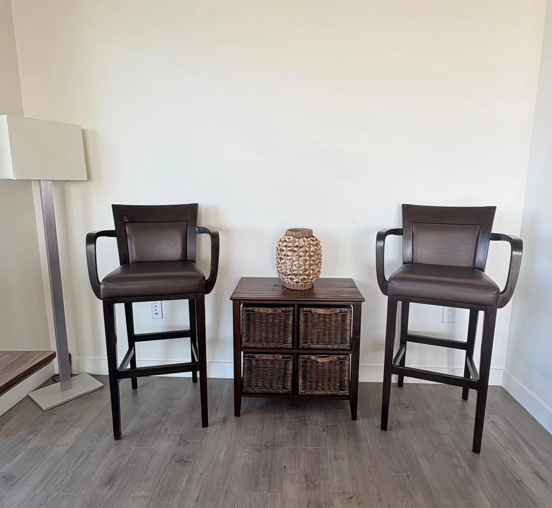 Two dark brown wooden bar stools