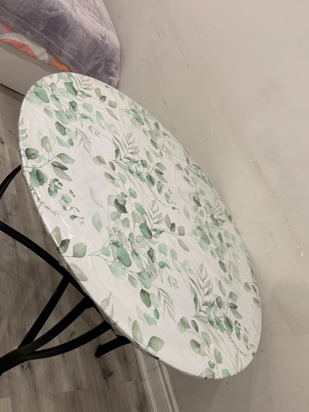 Round metal frame table with floral cover