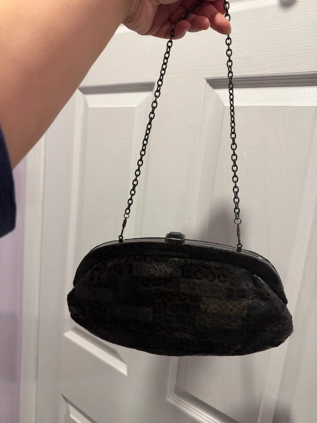 Black patterned clutch bag with chain strap