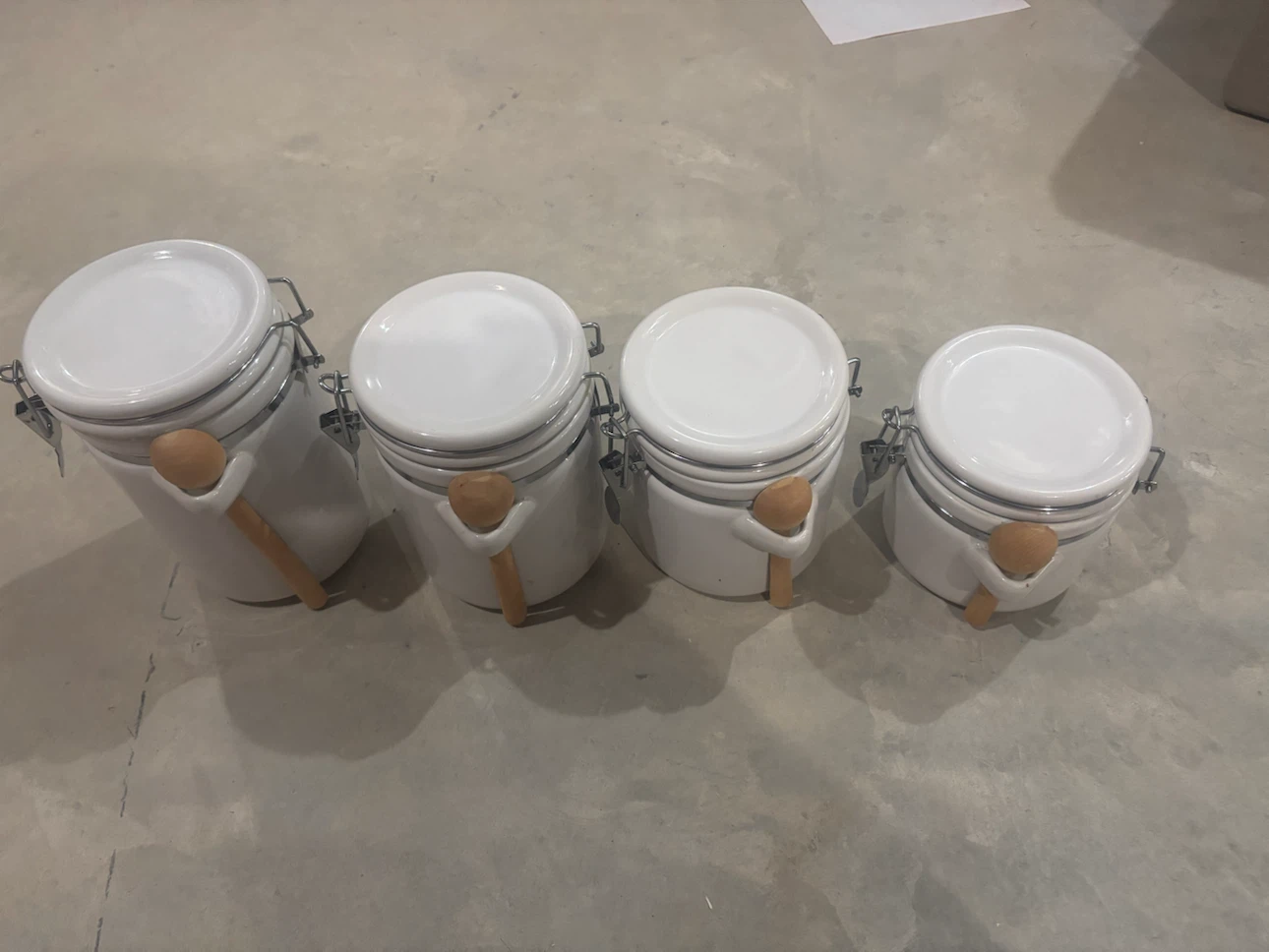 Set of 4 White Ceramic Canisters with Wooden Spoons
