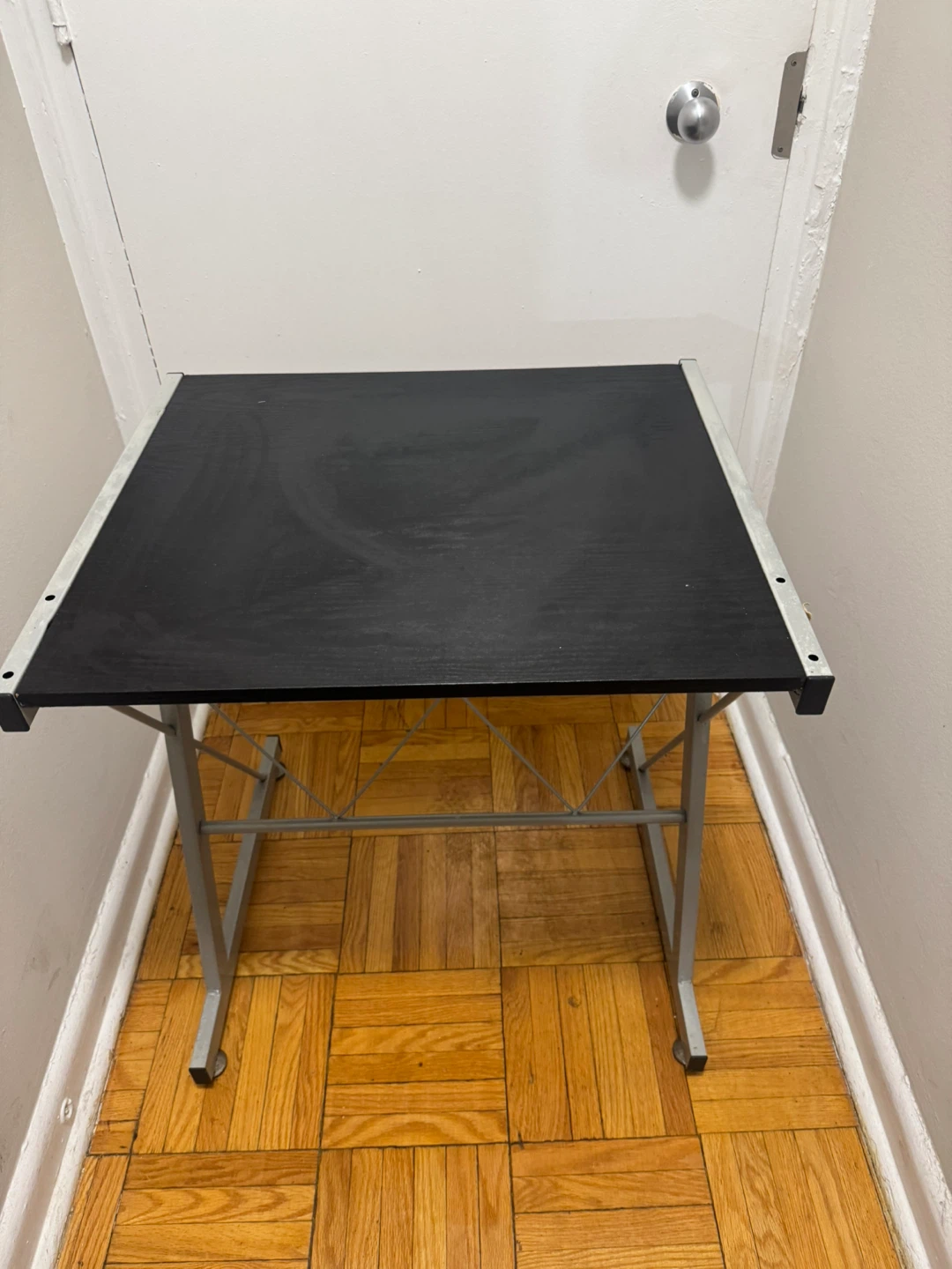 Compact black desk with silver metal frame