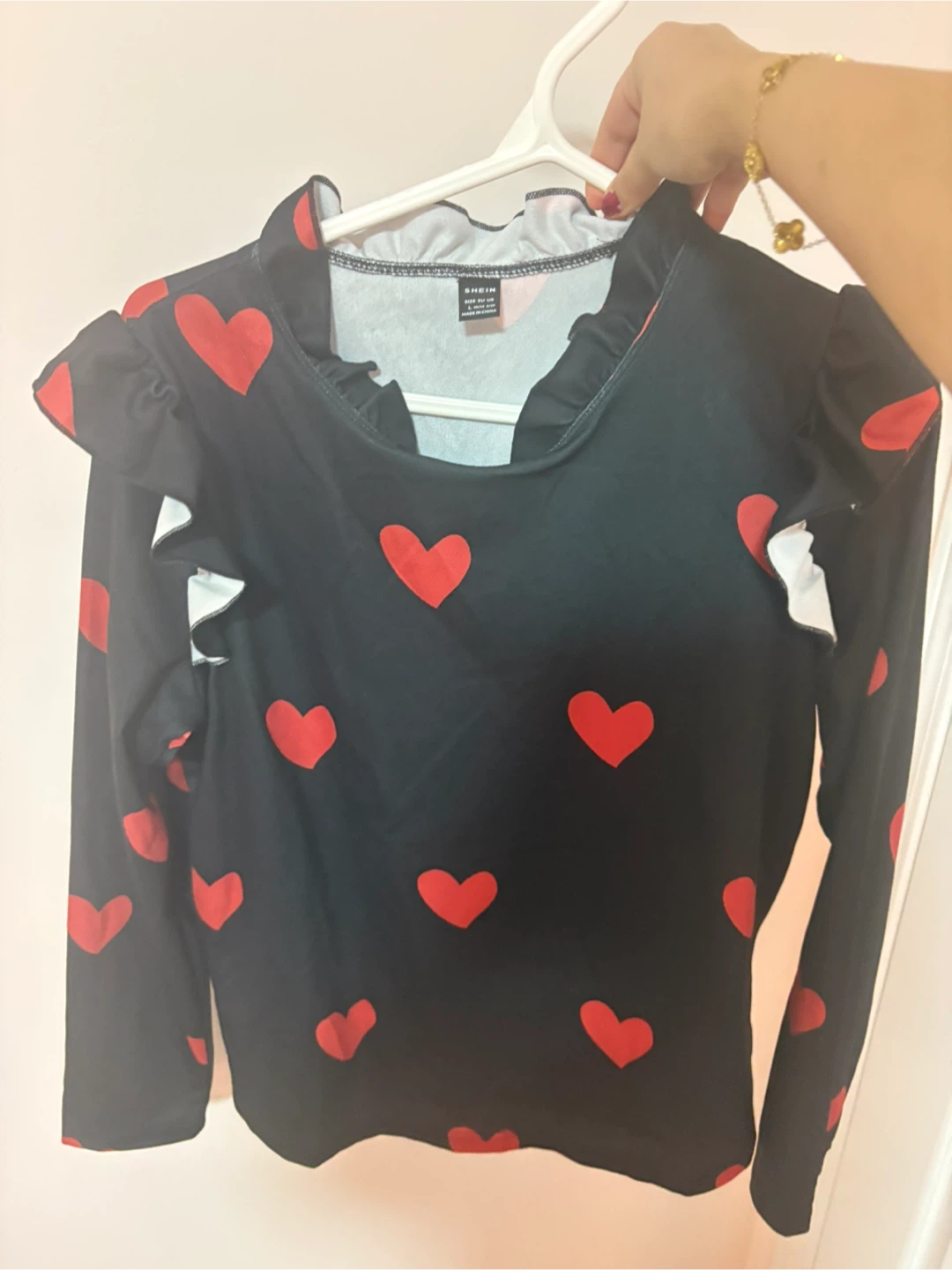 black long-sleeve top with red hearts, size L