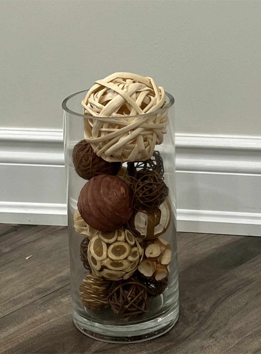 Decorative glass cylinder vase with rattan spheres