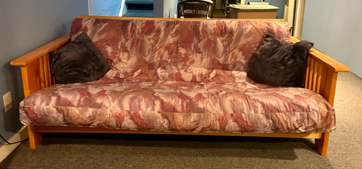Free futon couch in pine frame. Opens to a double bed.