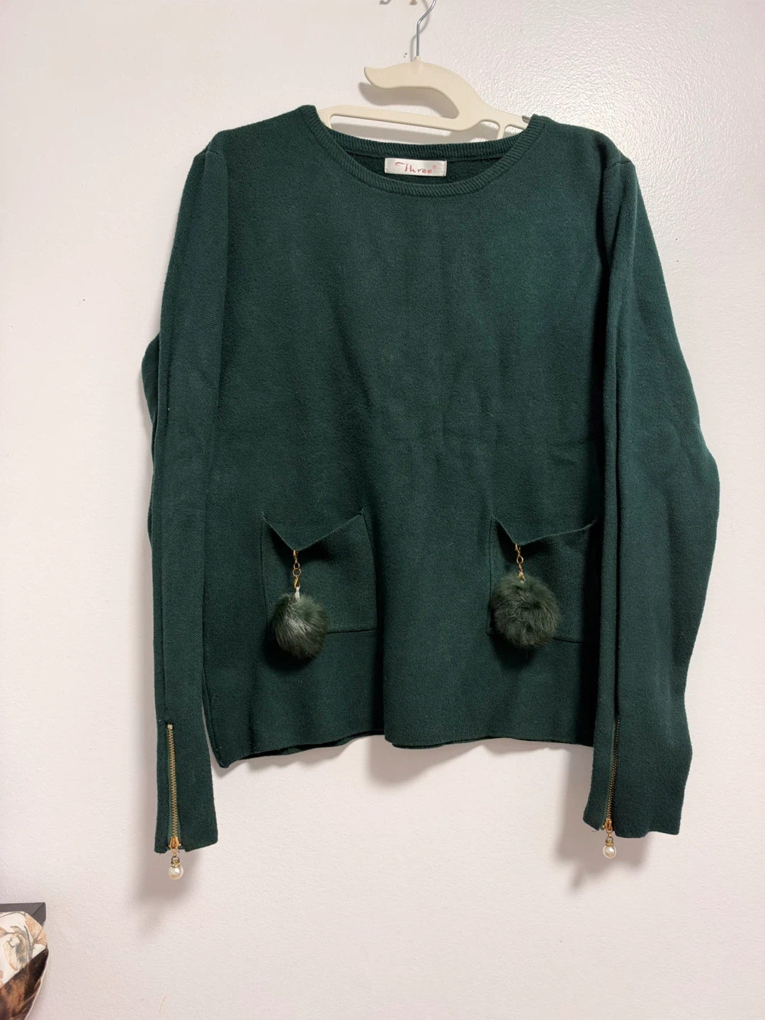 Three dark green knit sweater