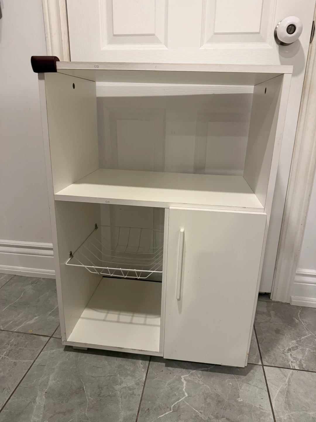 White storage cabinet with wire basket