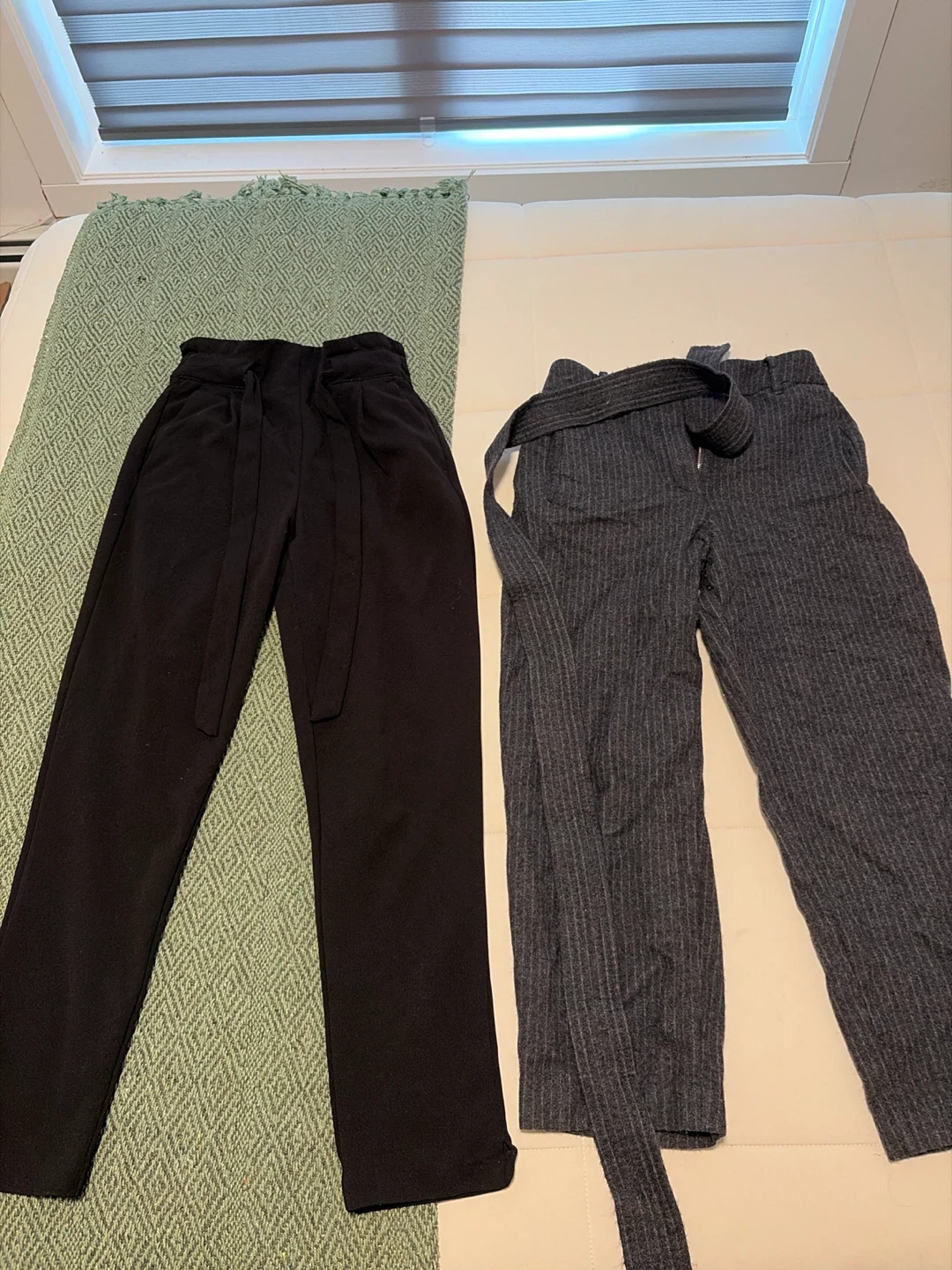 Two pairs of belted trousers
