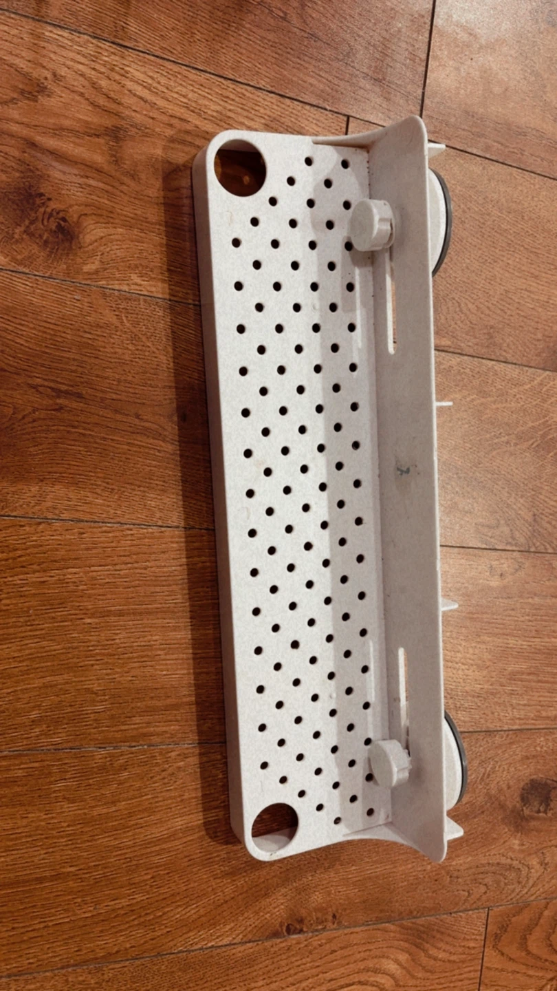 $1….White suction cup shower shelf