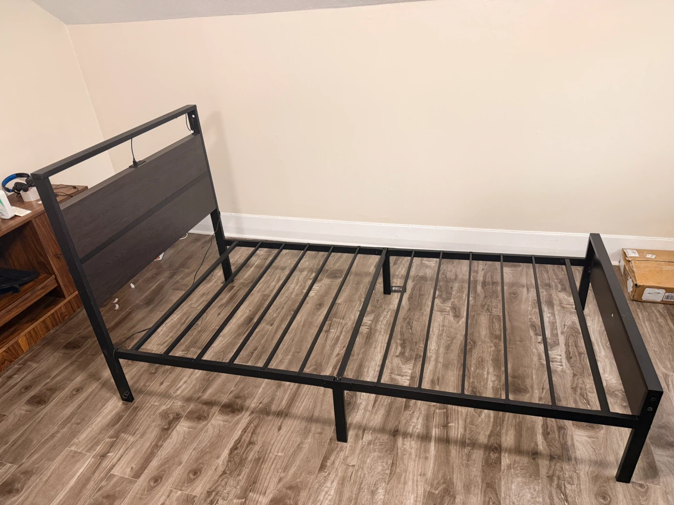 Single size metal bed frame with dark wood headboard