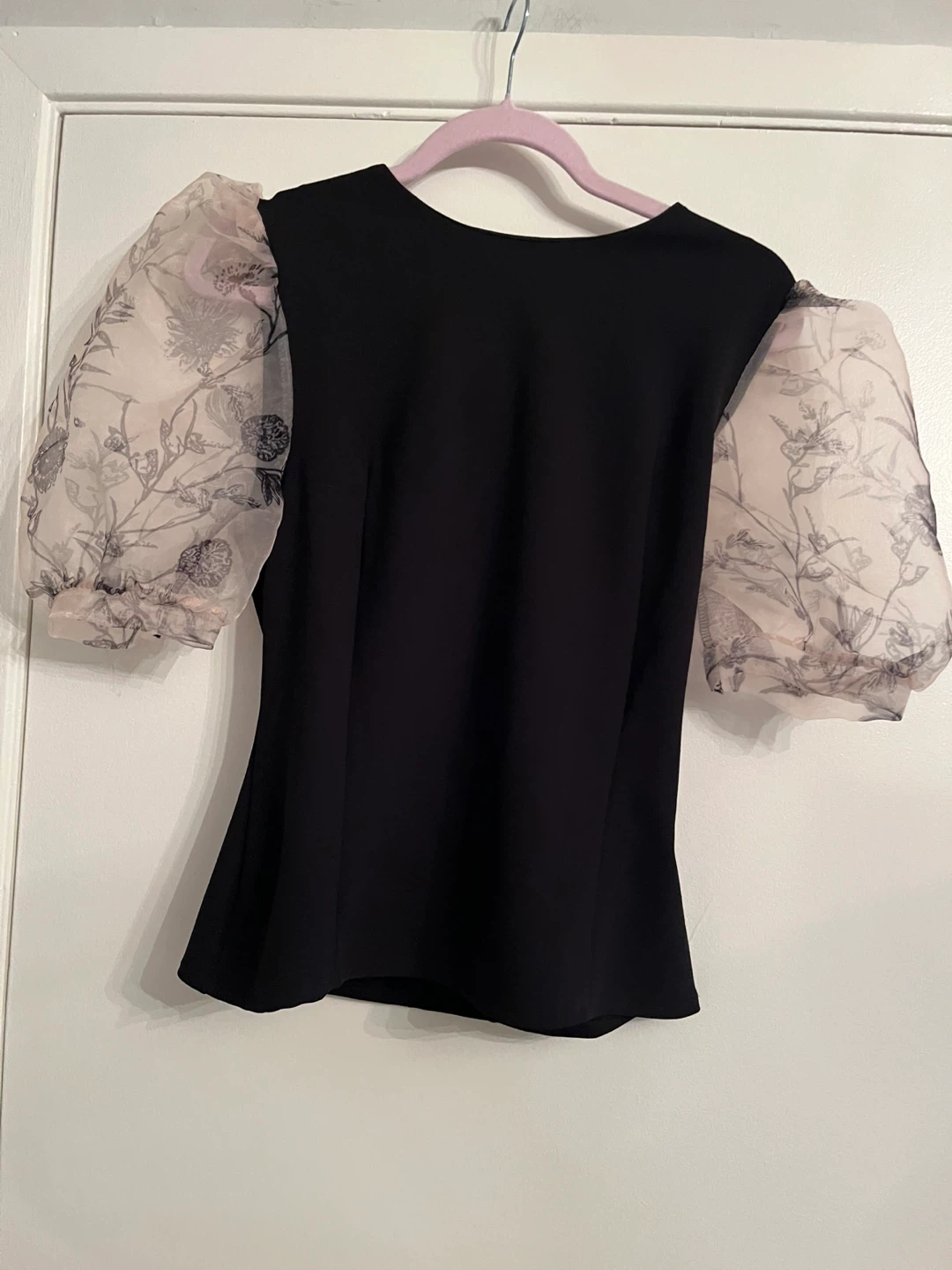 Black blouse with sheer floral puff sleeves