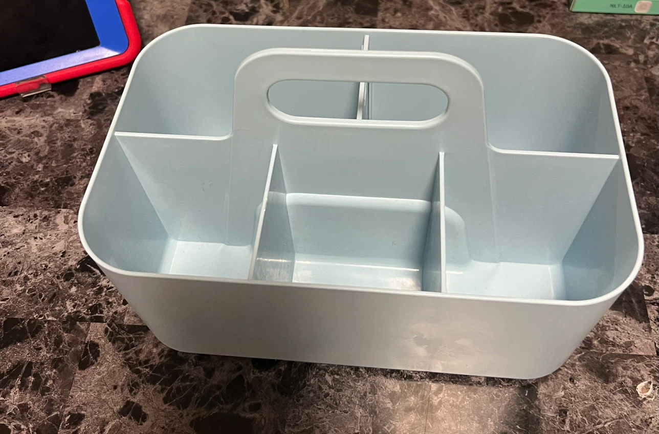 Light blue plastic storage caddy with handle