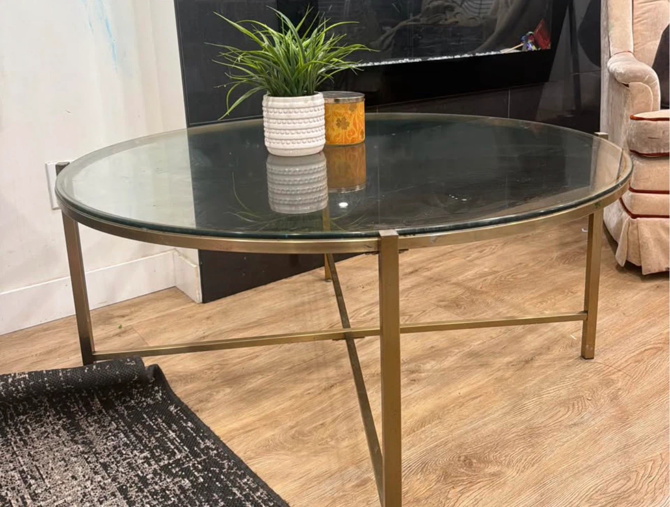 Round glass coffee table with brass base