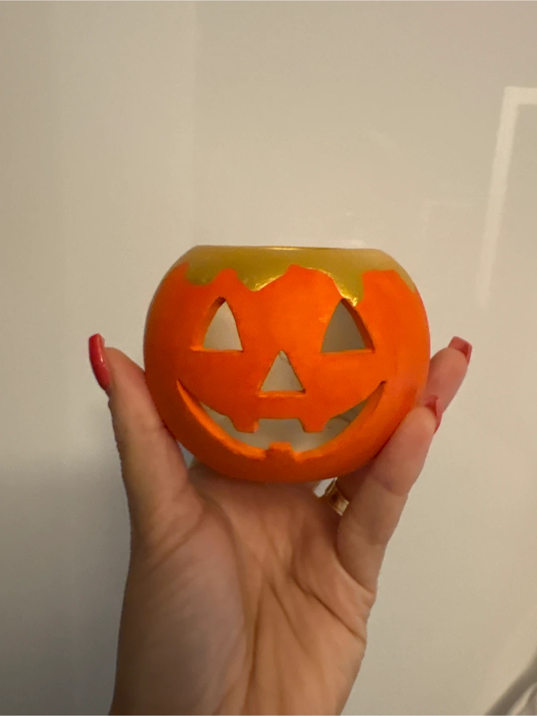 Small orange jack-o'-lantern candle holder