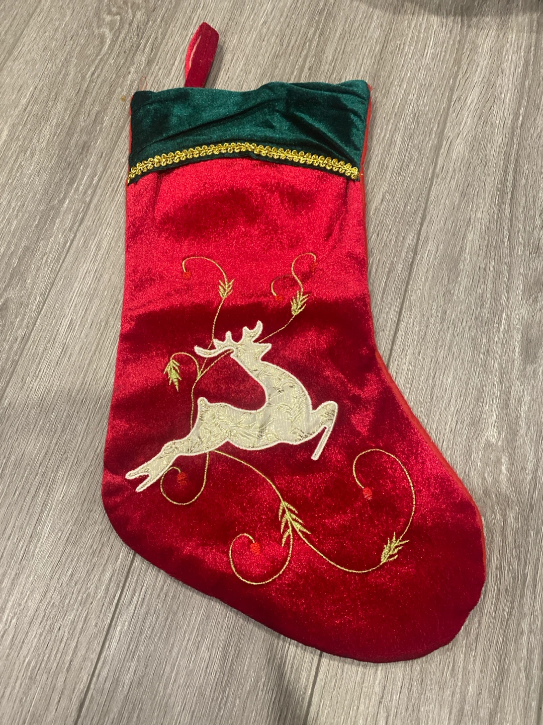 Red Christmas stocking with reindeer embroidery