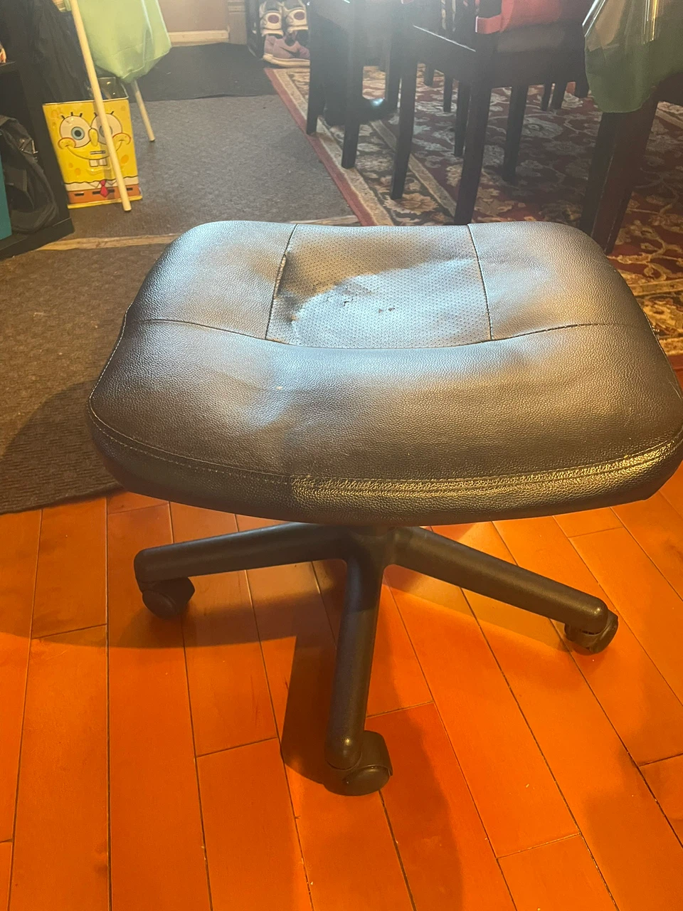 Black rolling ottoman seat