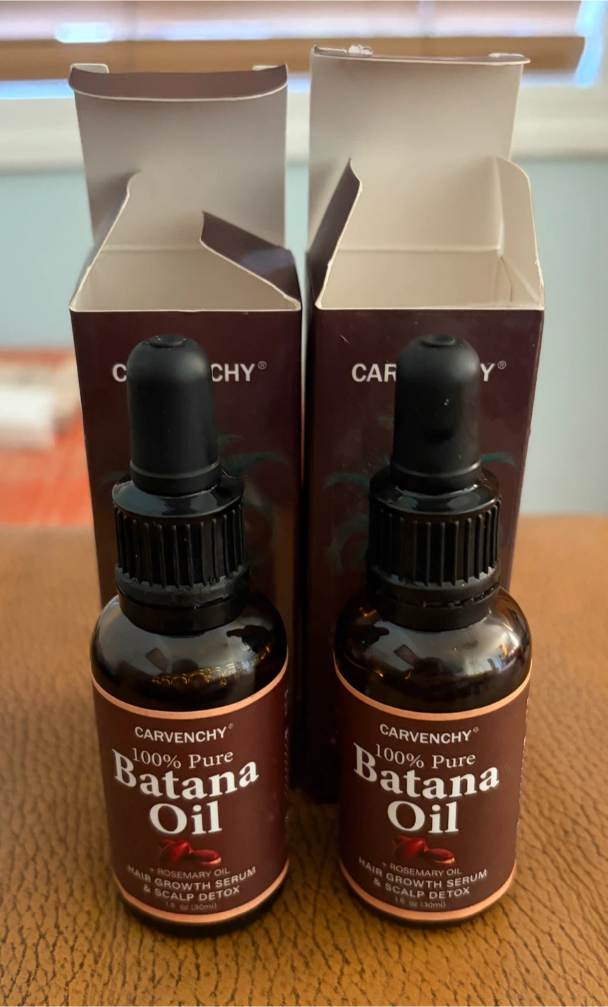 Two Carvenchy Batana Oil + Rosemary Oil Bottles