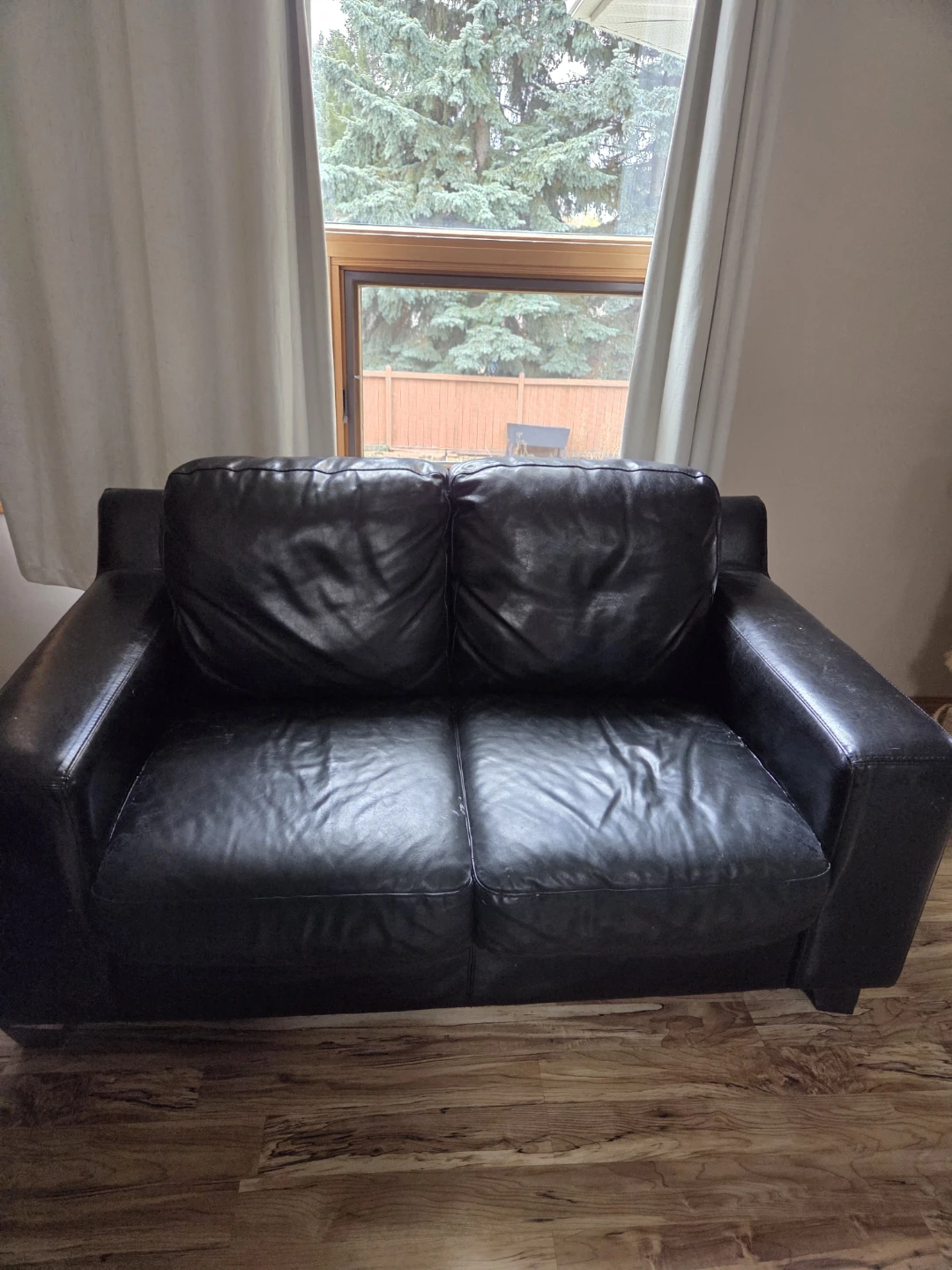 Black two-seater leather sofa