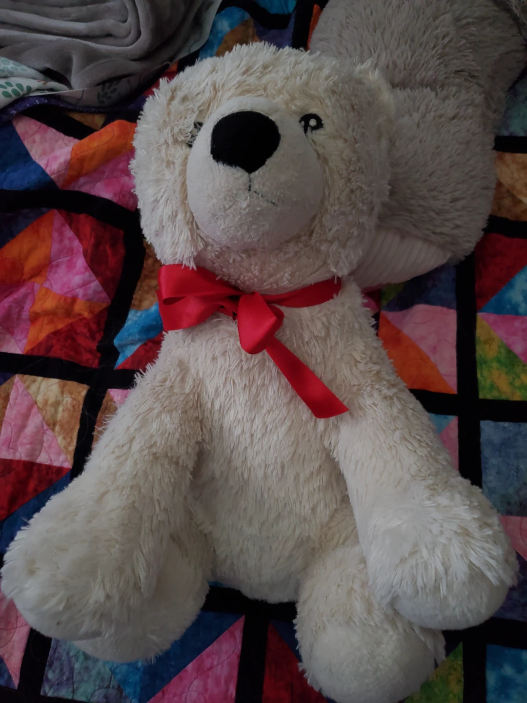 Cream teddy bear with red ribbon