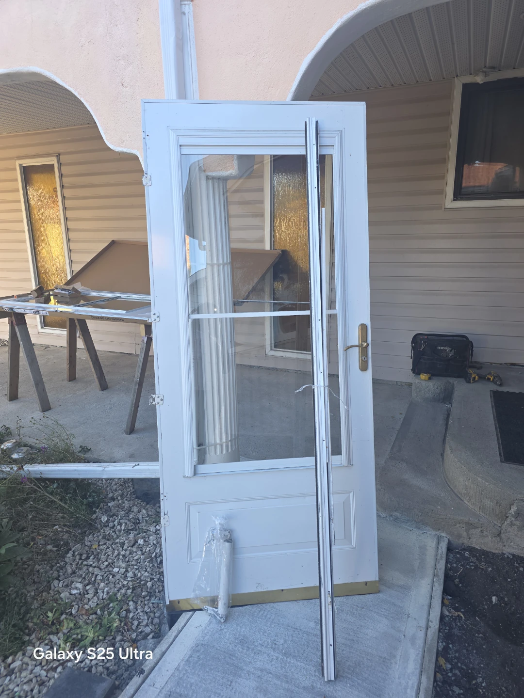 White storm door with brass hardware