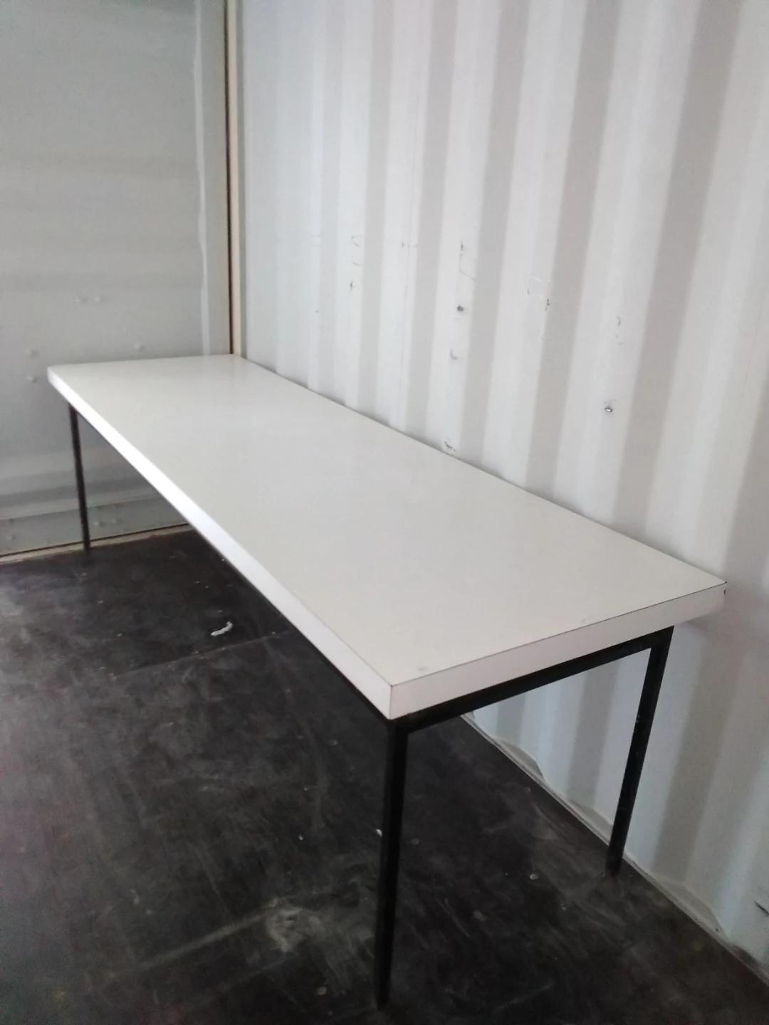 Heavy non-collapsible white laminate table with steel legs
