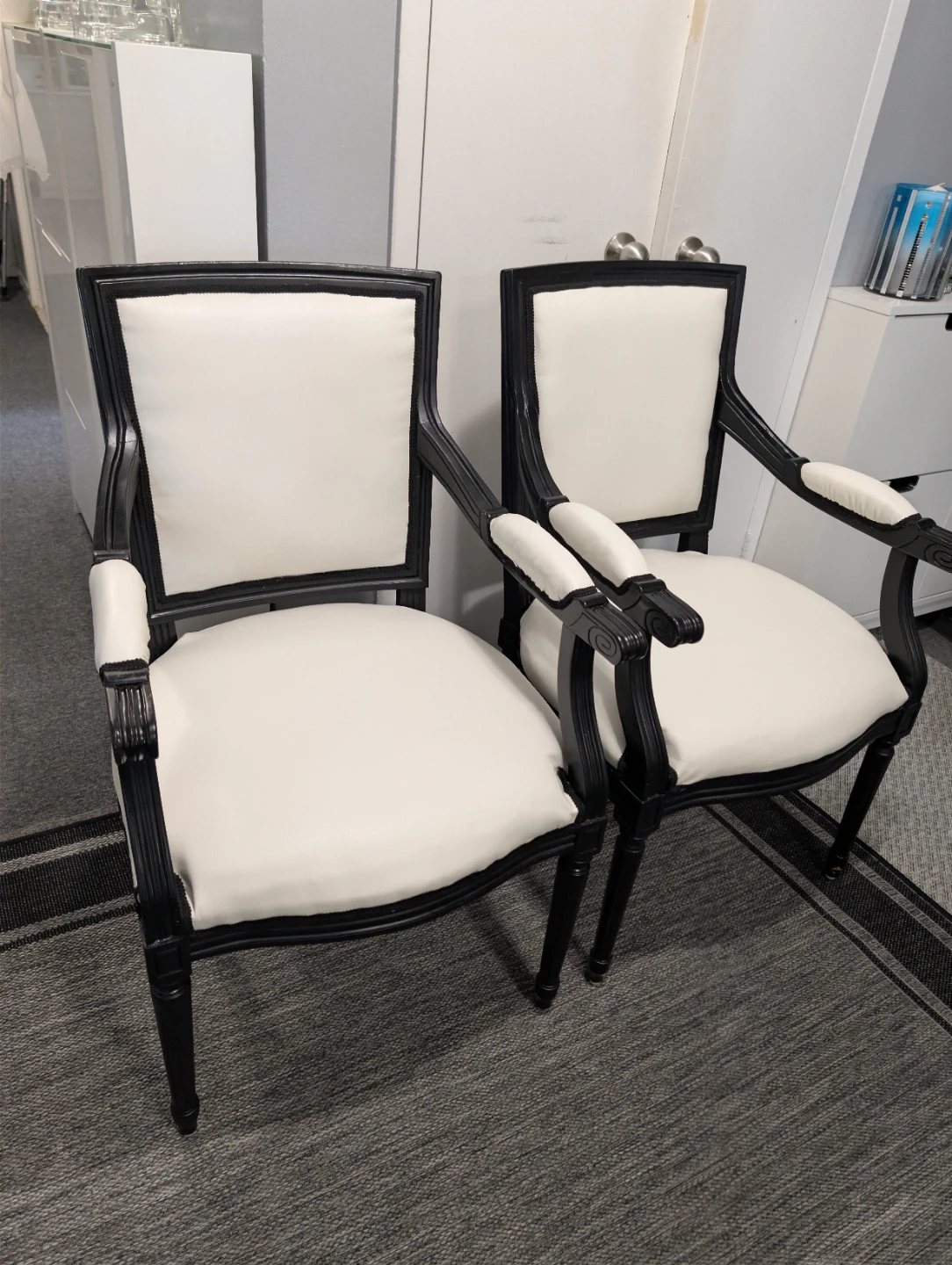 Two black and white accent chairs