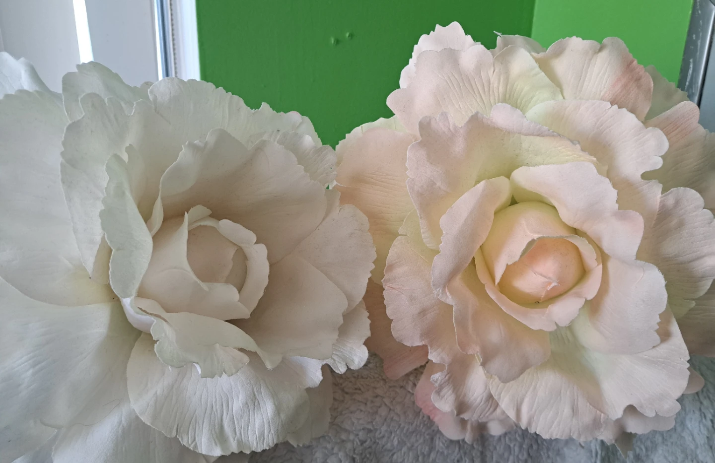 Two large decorative artificial flowers
