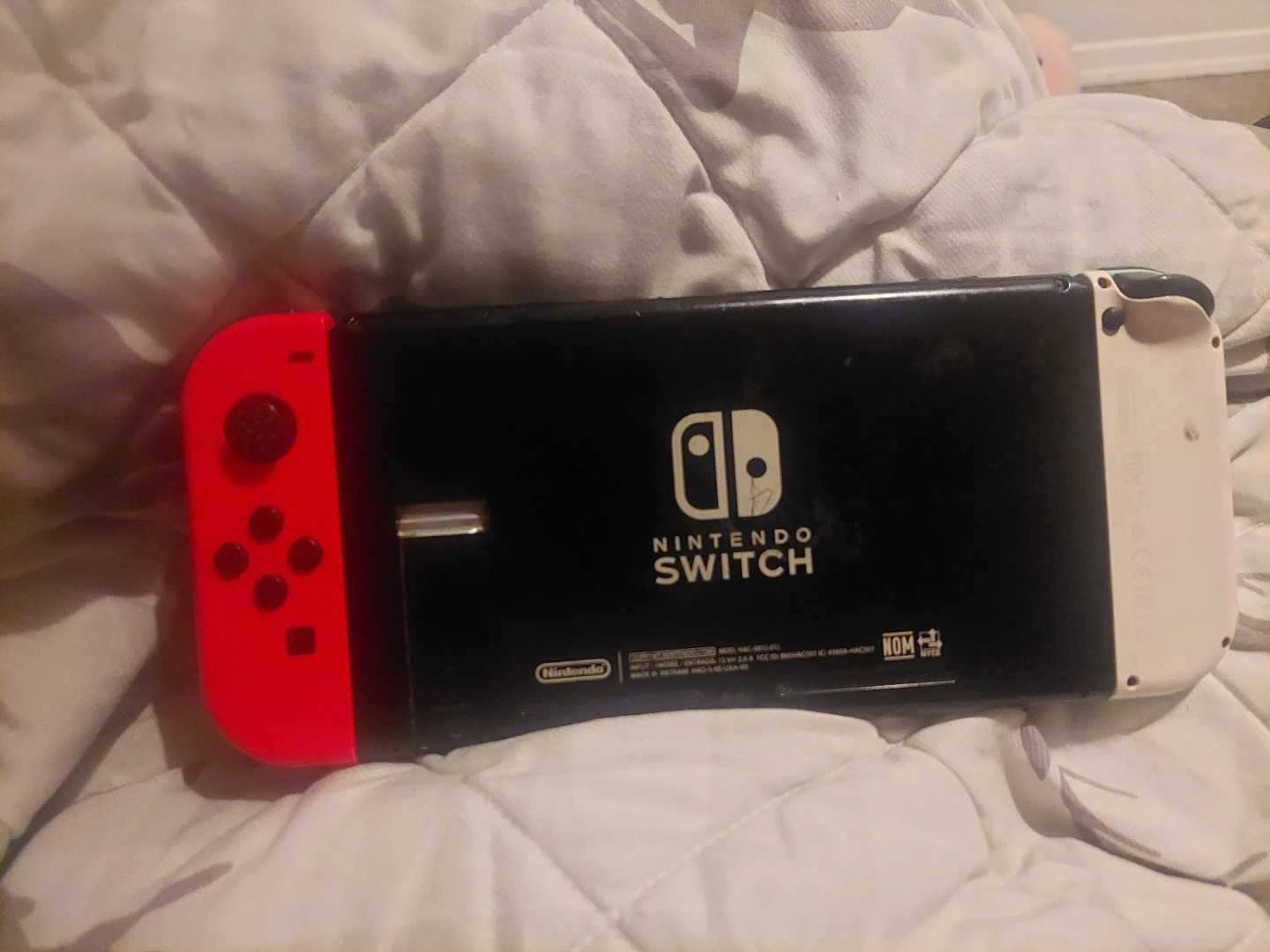 Nintendo Switch console with neon Joy‑Con pair
