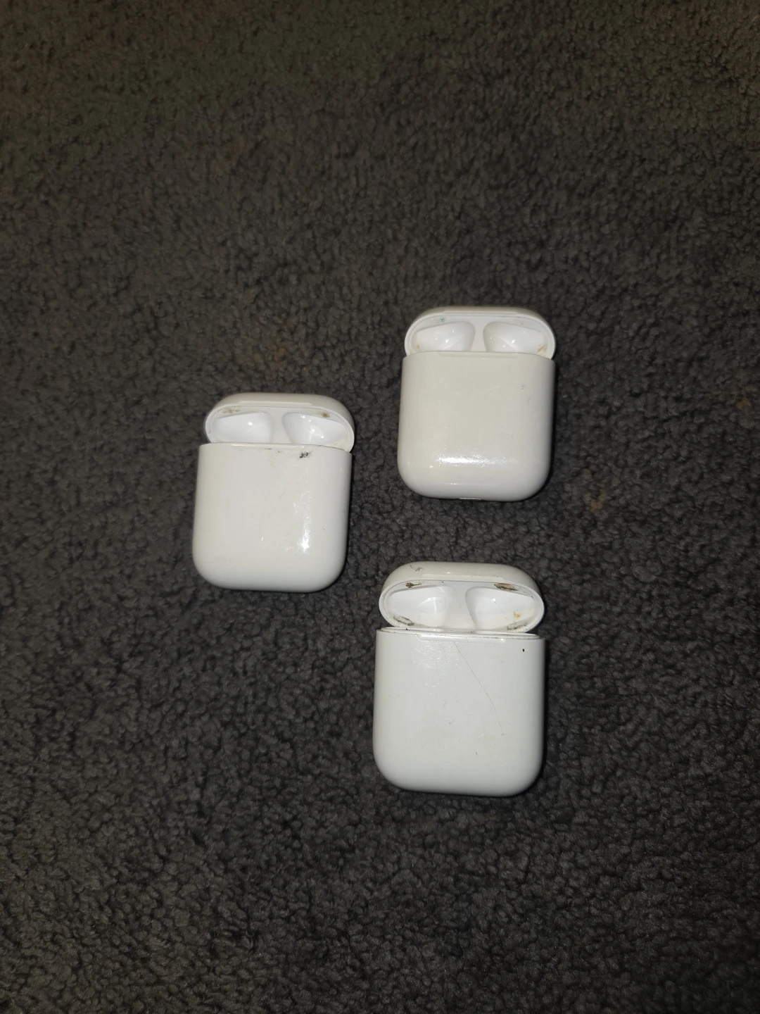 Three Apple AirPods Charging Cases