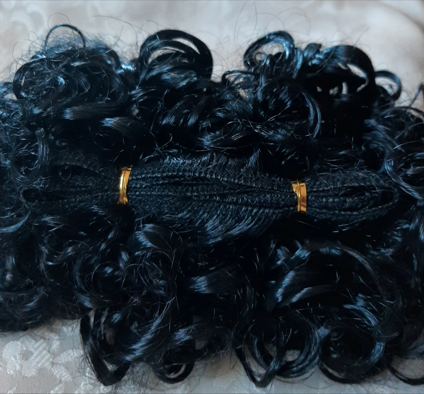 Black curly synthetic hair extension piece
